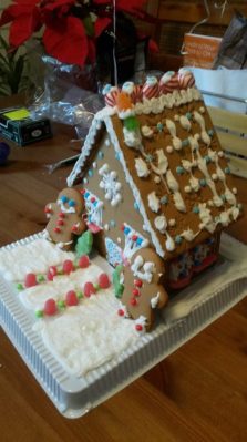 Decorated gingerbread house with two gingerbread men